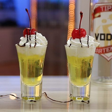 BANANA SPLIT SHOT 3/4 oz. (22ml) Vodka 3/4 oz. (22ml) Creme De Banana 1/4 oz. (7.5ml) Vanilla Syrup Garnish: Whipped Cream, Chocolate Syrup, Maraschino Cherry PREPARATION 1. In an ice filled glass combine vodka, creme de banana and vanilla syrup. Shake well. 2. Strain mix into shot glasses and top with whipped cream. 3. Drizzle chocolate syrup on top and garnish with a Cherry. DRINK RESPONSIBLY! Fruity Shots, Shots Alcohol Recipes, Whipped Cream Chocolate, Shooter Recipes, Bartender Drinks, Cocktail Drinks Alcoholic, Banana Drinks, Shots Alcohol, Vodka Shots