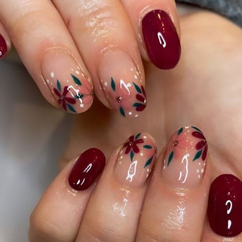 It can be anything, as long as it's holiday-themed! Cute Short Acrylic Nails Burgandy, Winter Floral Nail Art, Burgundy Flower Nail Designs, Burgundy Nails Flowers, Burgundy Nails With Flowers, Maroon Floral Nails, Fall Nail Flower Designs, Burgundy Floral Nails, Dark Red Flower Nails