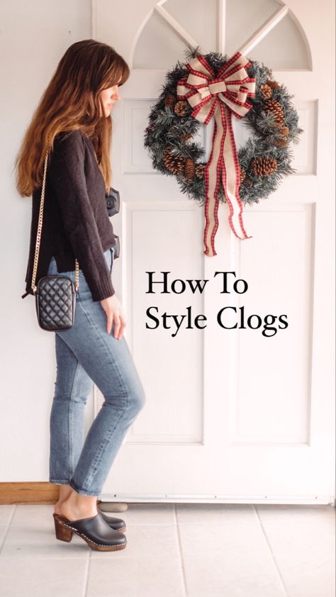 Woman wearing a black sweater straight jeans and clogs Styling Clogs 2022, Wedge Clogs Outfit, Black Platform Clogs Outfit, Clog Skirt Outfit, How To Wear Clogs 2022, Outfits With Clogs Spring, Brown Clog Outfit, Wide Leg Jeans And Clogs Outfit, Outfits With Black Clogs