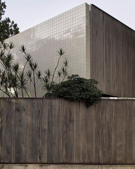 A two-inch thick solid wood fence encloses Casa Mendoza house, with a similar wood lattice cladding the first floor on most sides. However, the facade facing the busy Superi Street is clad in Portuguese tiles to offer a more durable defense against the constant traffic. Project by @labase__arch Photography @estudiopalma Arch Photography, Wood Lattice, Wood Facade, Portuguese Tiles, Wood Fence, Mendoza, Lattice, Defense, Instagram A