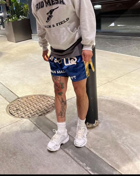 Outfit idea with Thai boxing short and the model has a great tattoo in his leg : coloured rose with black and white angel Boxing Shorts Outfit Men, Boxing Shorts Outfit, Shorts Outfit Men, Pride 2024, Thai Boxing Shorts, Clever Tattoos, Mens Shorts Outfits, Thai Boxing, Boxing Shorts