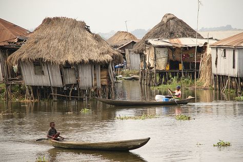 Benin - Boats crossing before the houses of Ganvie, a floating village in Lake Nokoue Raised Architecture, Dystopian Slums, People In Space, Floating Village, Body Painting Festival, Shanty Town, Village Photos, Water House, Village Photography