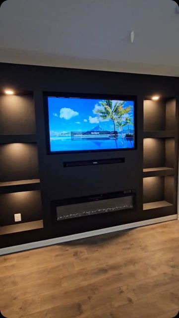 Modern Accent Wall on Instagram: "This Media Center wall deserves an ENCORE 👏🏼✨! #ModernAccentWalls #LuxuryCustomWalls #TricornBlack #LivingRoomGoals #familyRoom #MediaCenter" Black Accent Wall With Fireplace And Tv, Entertainment Wall Ideas Living Room, Black Wall Behind Tv, Accent Wall Basement, Tv Accent Wall Ideas Mounted Tv, Accent Wall Behind Tv, Wallpaper Tv Wall, Bar Wall Ideas, Built In Tv Wall Unit