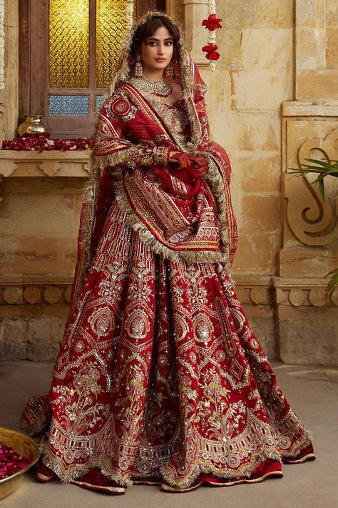 The bridal Red Lehenga Choli and Dupatta in Premium Raw Silk is an embellished masterpiece emblazoned with Tilla, Resham, and Zari details. Custom sizes. Red Lehenga Choli, Red Bridal Dress, Bridal Lehenga Designs, Latest Bridal Lehenga, Wedding Lehenga Designs, Bridal Lehenga Red, Salwar Kamiz, Red Lehenga, Bridal Dress Fashion