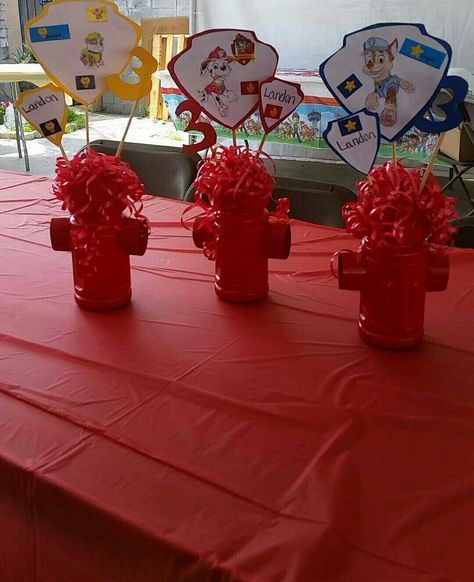 Paw patrol centerpieces! #3rdBirthday #PawPatrol Fire hydrants with ribbon. Looking at them now, i would have put blue ribbon (to look like water) instead of red. And i would have done another skewer in there with my sons picture on it.  Made with small gatorade bottles, toilet paper rolls, and styrofoam balls Paw Patrol Birthday Centerpieces Diy, Paw Patrol Center Piece Ideas, Diy Fire Hydrant Centerpieces, Paw Patrol Party Centerpieces, Paw Patrol Centerpiece Ideas, Paw Patrol Centerpieces, Diy Paw Patrol, Paw Patrol Centerpiece, Gatorade Bottles