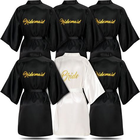 PRICES MAY VARY. Bridal Party Satin Robes: the package includes 1 piece of white bride robe and 5 pieces of black bridesmaid robes, measuring about 34.7 inches long, soft satin sleepwear for bride and bridesmaid, suitable for bridal shower, wedding shower, bachelorette party, bridesmaid night party, bridal party, sleeping, bathing, and lounging, let you shine any time Reliable Material: these wedding satin robes sets back with gold glitter are made of imitation silk that's silky, soft and smooth Wedding Party Robes, Bridesmaids Robes, Wedding Robes, Satin Robes, Robe Wedding, Wedding Slippers, Black Bridesmaids, Matron Of Honor, Bridal Party Robes