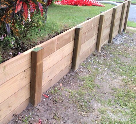 Get instructions on how to build a wood retaining wall by yourself using lumber available at your local home improvement store. Cheap Retaining Wall, Wooden Retaining Wall, Level Garden, Wood Retaining Wall, Diy Retaining Wall, Plant Bed, Backyard Retaining Walls, Building A Retaining Wall, Garden Retaining Wall