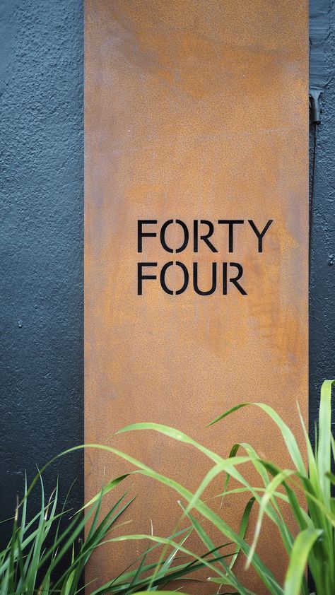 corten steel unit number plate with black painted facade Corten Steel Front Door, Copper Signage, Corten Steel Signage, Outdoor Signage Design, Corten Steel Facade, Steel Signage, House Gates, Super Safari, Shop Front Signs