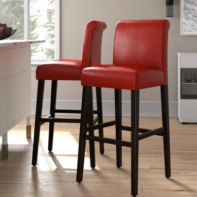 Sidle up to your kitchen island or your home bar with this set of two bar stools, and give your space a traditional feel. Each piece has a solid wood frame with a sleek black finish, and it rests on a 4-leg base with straight legs and a footrest on all sides. The rectangle seat and full back are wrapped in foam-filled faux leather for a little extra cushion as you enjoy your morning cup of coffee or a nightcap before bed. A faintly scrolled top provides the final finishing touch to this set. Sea Red Bar Stools, White Bar Stools, High Stool, Leather Bar Stools, Warm Red, Red Kitchen, Wood Bar Stools, Bar Counter, Kitchen Stools