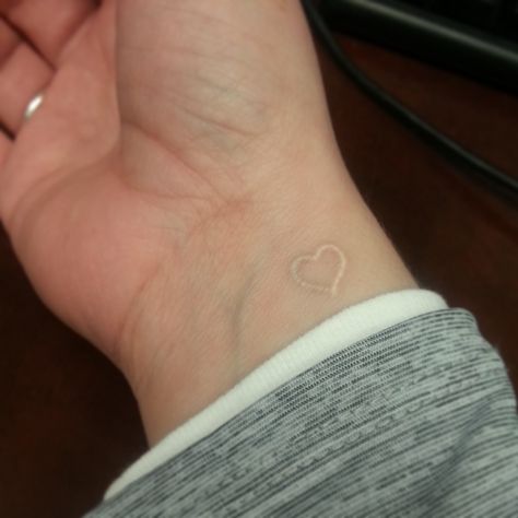 White tattoo. Love it. I want a tattoo on my wrist with the word strength in script Small White Tattoos, White Heart Tattoos, Small Heart Tattoo, White Ink Tattoos, Heart Tattoo Wrist, Tattoo Wrist, White Tattoos, White Ink Tattoo, Small Tattoos With Meaning