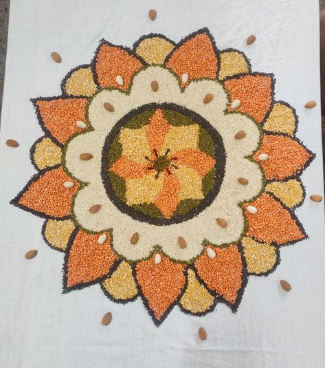 Easy and beautiful rangoli with grains and pulses Rangoli With Grains And Pulses, Grain Rangoli Design, Rangoli Designs With Rice, Pulses Art, Makarsankranti Rangoli, Rice Rangoli, Ganpati Aarti, Easy And Beautiful Rangoli, Rice Art