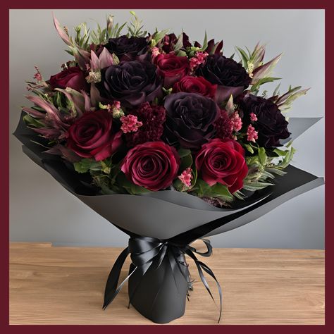 Boujee Burgundy Gothic Romance Bouquet Indulge in the opulence and mystery of the "Bougee Burgundy Gothic Romance Bouquet," a luxurious arrangement that embodies the essence of gothic elegance. Available in a stylish vase or wrapped in beautiful waterproof decorative wrapping, this bouquet is designed to captivate and enchant with its deep, rich hues and sophisticated presentation. Key Features: Gothic Elegance: Featuring a dramatic mix of burgundy, deep red, and a touch of dark purple blooms, t Dark Floral Wedding Bouquets, Wedding Centerpieces Gothic, Black Rose Flower Arrangements, Dark Romantic Bouquet, Deep Red Flower Arrangements, Goth Floral Arrangements, Dark Flowers Bouquet, Gothic Bouquet Wedding, Burgundy And Plum Wedding