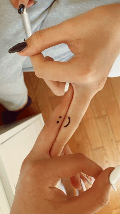 110 Minimal Tattoo Designs That Are Far From Simplistic |  tattoo ideas for couples disney Matching Tattoos Smiley Face, Mini Tattoos For Sisters, Finger Tattoo Best Friend, Hand Tattoos For Best Friends, Simple Small Matching Tattoos, Matching Smiley Face Tattoos, Finger Tattoos For Sisters, Finger Tattoos Friends, Finger Tattoos Sisters