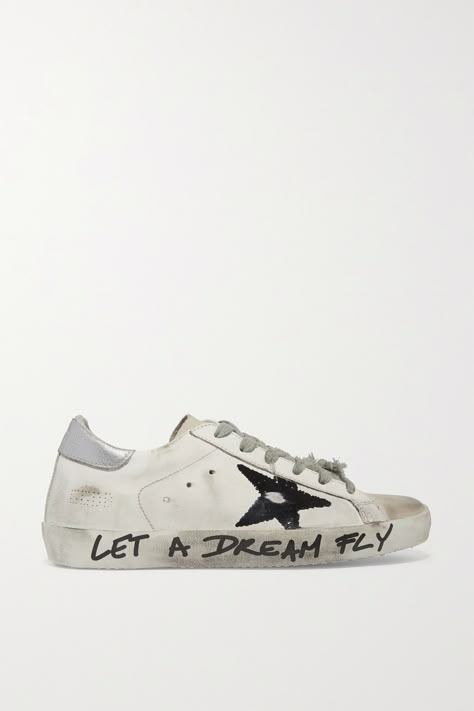 Golden Goose gives its signature 'Superstar' sneakers a skater-inspired refresh. Made from hand-distressed leather, this pair is printed with a graffiti-style star motif and the phrase "Let a Dream Fly" written along the sole. They have a silver heel and tag stitched into the tongue that reads "for skateboard use only" - but we think they work well for city streets, too.Shown here with: [James Perse T-shirt id1157334], [Isabel Marant Étoile Jacket id1153684], [Joseph Pants id1148862], [Loewe ... Golden Goose Costumized Ideas, Custom Golden Goose, Golden Goose Outfit, Silver Heel, Golden Goose Superstar, Star Motif, Shoe Wishlist, Style Star, Golden Goose Shoes