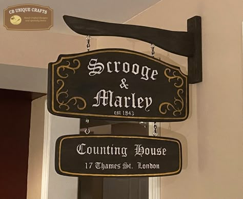 "Scrooge & Marley deluxe hanging sign with mounting bracket - double sided. . Made out of solid pine, hand painted dark brown with white lettering and gold pin striping. Finished with a protective satin clear. Overall Measurement:  17.5\" wide, 18\" high." Scrooge Christmas Door, Scrooge And Marley Sign, Scrooge Door Decorations, A Christmas Carol Themes, Xmas Carols, Scrooge Christmas, Christmas Booth, Antique Christmas Tree, Christmas Classroom Door