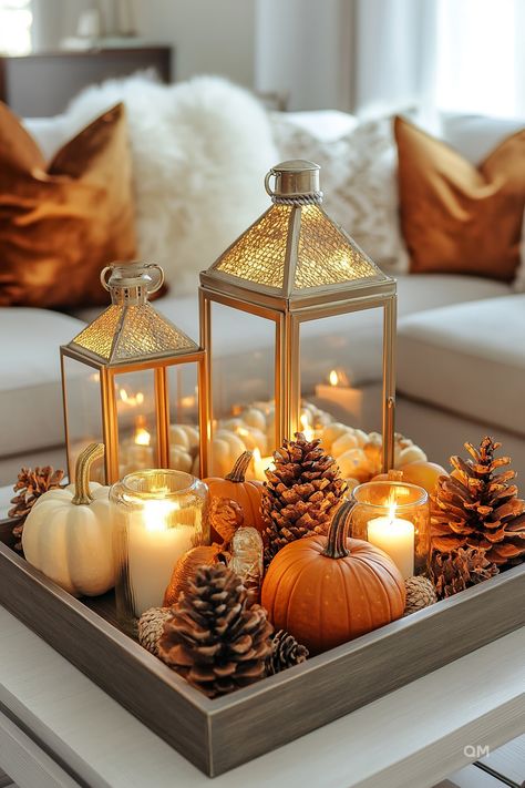 Elegant fall centerpiece with lanterns, candles, pinecones, and pumpkins in a tray, creating a cozy fall decor aesthetic in a living room. Autumn Indoor Decor, Autumn Table Centerpieces, November Decorations, November Decor, Personalized Fall Decor, Autumn Centerpieces, Fall Centerpieces For Table Diy, Fall Centerpiece Ideas, Autumn Table Decor