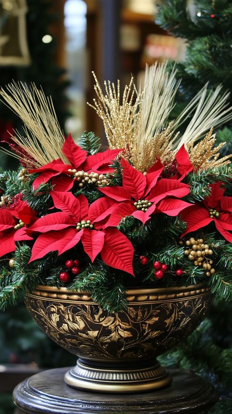 Festive winter planter with red poinsettias, green pine, and gold accents in a bowl pot, set against evergreen trees. Poinsettia Display Ideas, Poinsettia Display, Christmas Planter Ideas, Poinsettia Arrangement, Christmas Planter, Holiday Planter, Metal Flower Pots, Winter Planter, Natural Christmas Decor