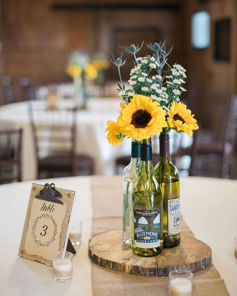 Stable At Bluemont Vineyard on Instagram: “Sunflowers and our favorite wine bottles make for a beautiful summer tablescape! #TablescapeTuesday #bluemontvineyardwedding 📸: @mroddaphoto” Wine Centerpieces, Wine Centerpiece, Sunflower Cafe, Wine Bottle Flowers, Wine Bottle Centerpieces, Sunflower Centerpieces, Bottle Centerpieces, Wedding Table Decor, Wine Wedding