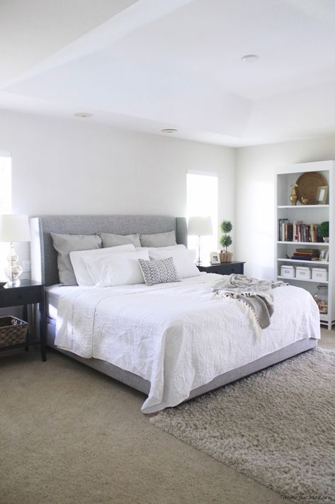 White bedroom with gray upholstered bed and large black nightstands Grey Upholstered Bed Bedroom, Upholstered Bed Bedroom, Gray Upholstered Bed, Grey Upholstered Bed, Grey Bed Frame, Bedroom Wall Designs, Boys Bedroom Decor, Up House, Trendy Bedroom