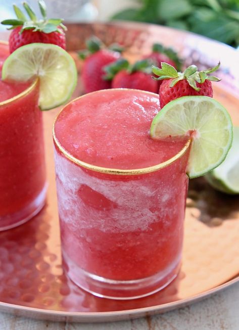 You'll feel like you're on vacation when you're sipping on this Frozen Strawberry Daiquiri recipe! It's easy to make at home & perfect for parties or poolside sipping! A delicious combination of basil simple syrup, strawberries, rum and lime juice create the perfect summer cocktail! Strawberry Daiquiri Recipe, Frozen Strawberry Daiquiri, Basil Simple Syrup, Frozen Drink Recipes, Daiquiri Recipe, Frozen Cocktail Recipes, Frozen Strawberry, Strawberry Drinks, Peach Sangria