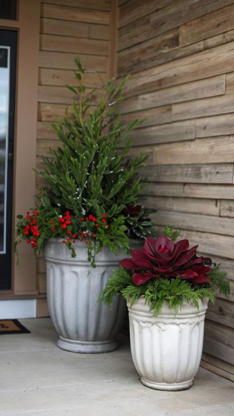 Transform your front porch into a winter wonderland with these stunning DIY outdoor winter planters Explore simple and easy ideas using fake tall Christmas trees pansies birch branches lanterns and more Perfect for adding a touch of festive charm to your home during the fall season You can create a cozy and welcoming atmosphere with these beautiful decorations inspired by a UK farmhouse aesthetic January Planter Ideas Front Porches, Winter Patio Plants, Winter Window Boxes Outdoor Cold Weather, Diy Porch Pots Christmas, Winter Front Porch Ideas After Christmas, Winter Flower Pots Outdoor, Front Porch Potted Plant Ideas, Winter Containers Planters, Winter Porch Pots Diy