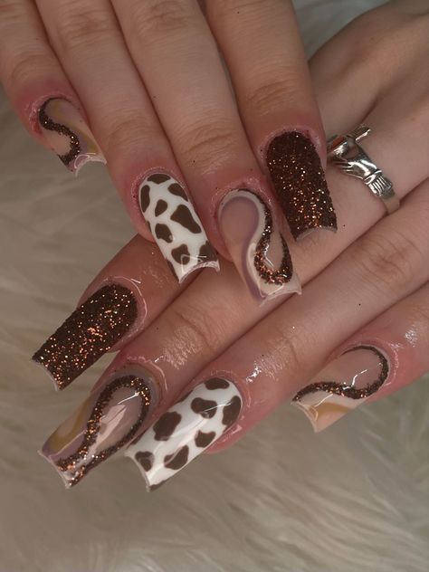 rown nails, brown glitter nails, cow print nails, brown nails, fall nails, luxury nails, sugar glitter nails, swirl nails, trendy nails, square nails, 2023 nails, y2k nails, nail art, nail inspo, gelx nails, gel extensions, baddie nails, hand painted nails, nail artist, brown swirl nails, abstract nails, nail set, funky nail set, nail set inspo, detailed nail art Fall Nails Cow Print, Brown Cow Print Nail Designs, Cow Fall Nails, Brown Square Nails Design, Brown Western Nails, Y2k Fall Nails, Cow Print Nails Brown, Square Nails 2023, Sugar Glitter Nails