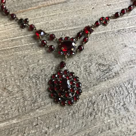 "Antique Garnet Necklace, Victorian Bohemian, Deep Color,  Period Jewelry, KH KH #7255N 9202308 Antique Victorian garnet necklace in a deep beautiful color. Three large stone with a 2\" center drop with layered stones in an oval pendant. A striking statement piece with gold chain. Measures;  Necklace measures; 15.25\" length however a portion of the chain was removed to wear in a shorter style.  The section is 2 5/8\" length and it is original to the piece (we will include with your purchase). Well preserved condition. Closure is working.  As mentioned in the measurement section, we will be included a portion of the chain links that are original however were removed at some point. Thanks for viewing. Happy to check on shipping prices and options. No returns on this item." Victorian Garnet Jewelry For Wedding, Antique Garnet Necklace, Ornate Red Pendant Jewelry, Ornate Red Garnet Jewelry, Period Jewelry, Victorian Garnet Necklace, Crystal Goddess, Large Stone, Jewelry Lockets