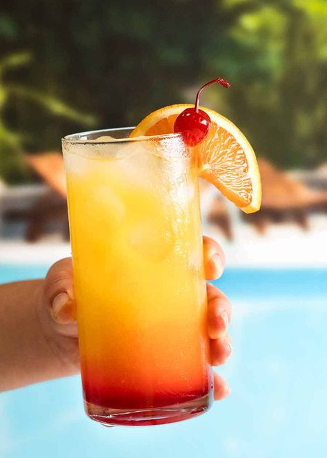 Hand holding Tequila Sunrise by a pool Tequila Orange Juice, Tequila Sunrise Recipe, Tequila Sunrise Cocktail, Sunrise Cocktail, Maraschino Cherries, Best Tequila, Colorful Drinks, Recipetin Eats, Tequila Drinks