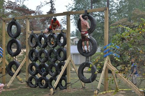 The DIY tire climbing wall. Made from junk yard tires, wood beams, and rope. Rope Playground, Playground Wood, Obstacle Course Ideas, Tire Playground, Camping Games For Adults, Backyard Obstacle Course, Kids Obstacle Course, Course Ideas, Wall Outdoor