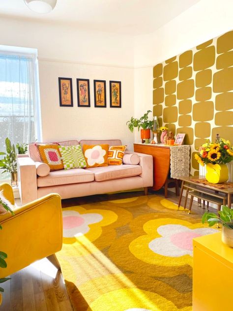 quirky interiors, interior design ideas, retro home, 60s interior design, 70s decor, yellow flower power rug, art deco wallpaper, living room redesign ideas, checkerboard print cushions, crochet blanket, yellow armchair, pink sofa 70s Room, 70s Living Room, 70’s Decor, 60s Interior, 70s Interior Design, Living Room Decoration Ideas, 70s Interior, Room Decoration Ideas, Retro Bedrooms