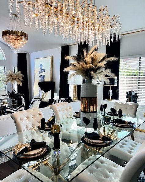 Wendy Millward on Instagram: "Happy Tuesday My Friends! Today I am featuring my living room and dining room in black, white, and gold! I love bold colors but this is currently my favorite color combination! Which colors would you like to see me post in the future? Please stay tuned for Las Vegas Market inspiration coming up soon! I am attending this amazing market this week! I hope you have a wonderful day!🖤💛🖤 . FOR LINKS FOR MY BEAUTIFUL PILLOW COVERS PLEASE COMMENT “PILLOWS” . . . . #glamdiningroom #glamdecor #glamdecorating #luxuriousdecor #blackandgold #chandeliers #chandelier #glamorousdecor #glamdesign #glamdesigner #gorgeousdecor #classydecor #classyinteriors #diningroomdecor #livingroominspiration #coffeetablestyling #europeandecor #greekstatue #greekstatus #greekkey #decor #pil Black And Gold Dining Table Decor, Silver And Gold Dining Room Decor, Black And White Dining Room Decor Ideas, Black And Gold Dining Room, Glam Apartment Decor, Boujee Apartment, Luxury Dining Room Decor, Luxury Room Design, Dining Room Glam