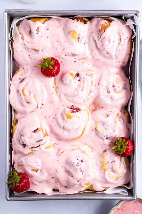 Fruity strawberry cinnamon rolls are a fun twist on the classic breakfast treat. Made with a quick and easy homemade jam filling and a pretty pink strawberry cream cheese icing. Strawberry Winter Rolls, Strawberry Rolls Recipe, Strawberries And Cream Cinnamon Rolls, Strawberry Rolls With Cream Cheese Icing, Fun Cinnamon Roll Ideas, Valentines Cinnamon Rolls, Flavored Cinnamon Rolls Homemade, Strawberry Cream Cheese Recipes, Cinnamon Roll Flavor Ideas