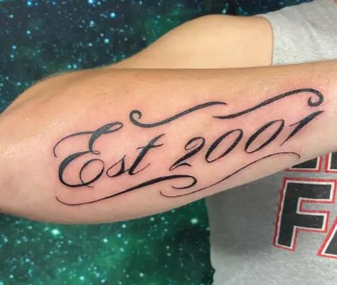 EST is an acronym for “established.” It is an acronym that businesses adore to indicate the year of their “birth” on their items. For instance, if a company was started in 1889, it might write “Est. 1889” on its label. People can accomplish the same goals as those businesses with EST tattoos. But it refers … 15 EST or Established Tattoo Ideas For Those Who Embrace Change Read More » The post 15 EST or Established Tattoo Ideas For Those Who Embr... Est 2005 Tattoo Ideas, Est Birth Year Tattoo, Est 2001 Tattoo Ideas, Est 2003 Tattoo, Est 2006 Tattoo, Est 2000 Tattoo Ideas, Birth Year Tattoo Ideas For Women, Est 2000 Tattoo, 2002 Tattoo Ideas