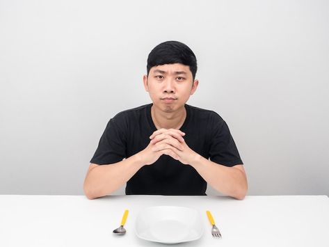 Man sit at table with dish waiting for d... | Premium Photo #Freepik #photo #asian-man #asian-male #excited-man #hungry-man Someone Sitting At A Table Reference, Sitting At The Table Pose, Person At Table Reference, Sitting At Dinner Table Pose, Person Sitting At Table Reference, People Sat Around A Table Reference, Person Sitting At Table, Man Leaning On Table Pose, People Sitting Around A Table