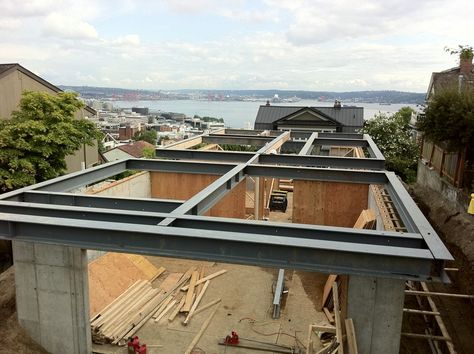 Will the steel mean future rot?  Steel I-beams that support cantilevered floors in this modernist Seattle home are proving difficult to insulate effectively. Steel Beam House Design, Steel Beam House, Post And Beam House, Beam House, Steel Beam, Metal Beam, Structural Steel, Seattle Homes, Steel Beams