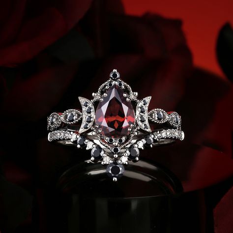 The striking contrast of red and black in ring design evokes an intense, dramatic elegance, merging passion and mystery into a bold statement of timeless beauty. Follow @starlandusjewelry for more nontraditional jewelry/alternative engagement rings! #ringselfie #ringlover #engagementring #jewelrybrand #jewelry #moissanitering #weddinginspo #diamond #moissaniteweddingring #jewelrydesigner #engagementringsforwomen #nontraditional #alternativebride #garnet #garnetring #garnetjewelry #foryoupag... Dark Fantasy Engagement Ring, Vintage Gothic Wedding Rings, Gothic Rings Engagement, Dark Engagement Ring, Fantasy Engagement Rings, Goth Engagement Rings, Jewelry Alternative, Gothic Wedding Rings, Gothic Engagement Ring