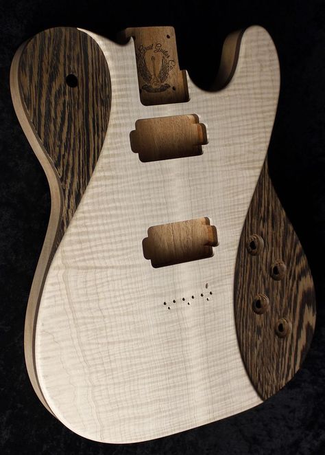 “Experience the craftsmanship of HolyGrail Guitar Company with our made-to-order Tuxedo Exotica Tele® Bodies. This Limited Edition features a flame maple top with distinctive curves and contours, beautifully paired with an exotic wenge middle layer and a mahogany back. Each guitar body is crafted upon order, ensuring a unique piece for each customer. Visit holygrailguitarcompany.com to start creating your personalized guitar today.” Guitar Bodies, Guitar Crafts, Telecaster Body, Guitar Inlay, Esp Guitars, Drums Sheet, Guitar Diy, Electric Guitar Design, Diy Instruments