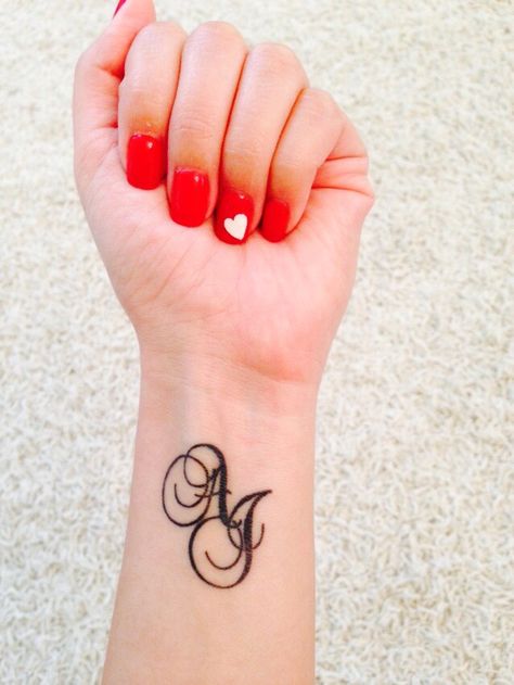 Initials tattoo with script AJ Aj Tattoo Design, Aj Tattoo, Hijab Instagram, Initials Tattoo, Hand Tattoo Images, Tattoo Lettering Styles, Omerta Tattoo, Tattoo Inspiration Men, Skeleton Hand Tattoo