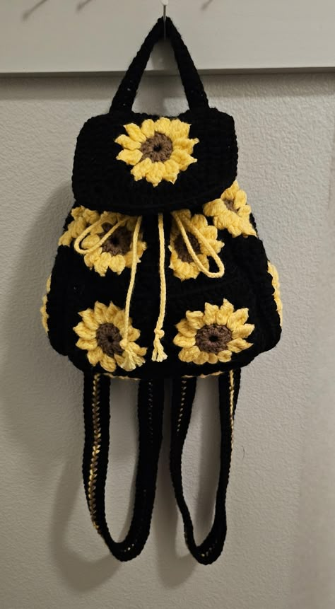 Handmade mini sunflower backpack is perfect for everyday use. Inside it has a black cloth liner sewn in and has approximately 9"x9"x4" of space. 100% Acrylic yarn Mini Backpack Crochet, Crochet Backpack Purse, Cute Crochet Backpack, Crochet Backpacks, Crochet Gift Bags, Sunflower Bag Crochet, Crochet Two Colors, Sunflower Bag, Fall Crochet Bag