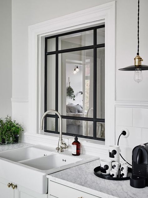 a cozy Scandinavian kitchen with a window with black frame to the bedroom to let more light inside both spaces Kitchen Window Ideas Modern, Kitchen Corner Ideas, Kitchen Window Dressing, Kitchen Window Shelves, Small Kitchen Window, Internal Window, Deco Studio, Indoor Window, Interior Windows