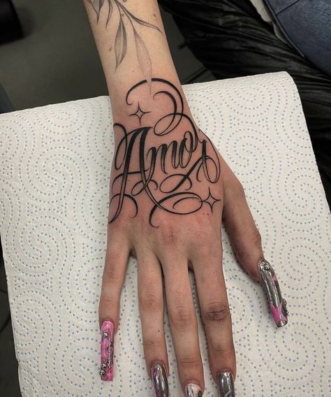 Name Tattoos Old English, Malachi Tattoo Name, Mexican Font Tattoo, Name On Hand Tattoos For Women, Raiders Tattoos For Women, Finger Name Tattoos For Women, Hand Tattoo Name, Hand Tattoo Lettering, Cursive Hand Tattoo