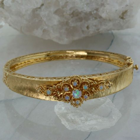 Retro Style 14K Yellow Gold Crystal Opal Hinged Bangle Bracelet, 4 mm central opal, 9 fine round cabochons with blue, green and yellow fire, stones are prong set, pierced decoration, florentine finish with polished areas to locking box clasp, 5/8 inch across, 9/16 inch high at center, Circa 1950, 24.4 grams Stock # BB555B03 This listing contains photographs of the actual item you will receive. Our items are in excellent condition with little or no signs of wear and many are one of a kind pre-own Gold Snake Jewelry, Vintage Gold Bracelet, Gold Jewelry Set, Dope Jewelry Accessories, Dope Jewelry, Crystal Opal, Box Clasp, Funky Jewelry, Jewelry Lookbook