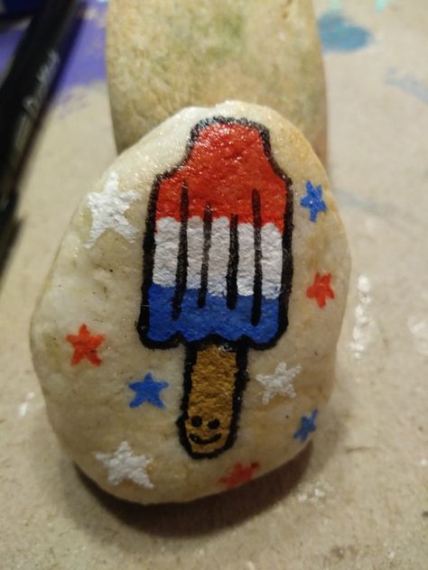 Popsicle Rock Painting, Firework Rock Painting, 4th Of July Rocks, 4th Of July Painted Rocks, Americana Painted Rocks, Patriotic Art Ideas, Chalk Signs, Rock Concert Rock Painting, Painted Seashells