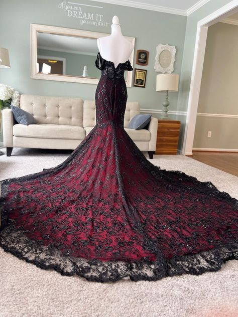 This gorgeous Black and Dark Red Wedding Dress with cape is definitely set to give any bride an ethereal, unforgettable look. The see through bodice has bonings for great support and the floral lace adds a very romantic look to the overall look. All dresses come with sewn in cups, and be customized in any size+ colors.  * This dress in the listing is in chapel train length ( 3 ft) / The cape veil is in Cathedral length ( 6 feet) Red And Black Prom Dress Ballgown, Gothic Vampire Wedding Dress, Red White And Black Wedding Dress, Wedding Dresses Black And Red, Dark Red And Black Dress, Black And Dark Red Wedding, Red Dress With Train, Black And Red Wedding Dress, Red And Black Formal Dress