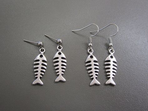 Creepy Fishbone Earrings Simple fish-bone charms hang from either little studs, or fish hook wires The fish bone earrings are made from a plated alloy, and the ear wires are made of a similar material. Surgical Steel hooks also available. Fish Bone Earrings, Fishbone Earrings, Physical Manifestation, Creepy Earrings, Fish Skeleton, Fish Earrings, Skeleton Earrings, Fish Jewelry, Bone Earrings