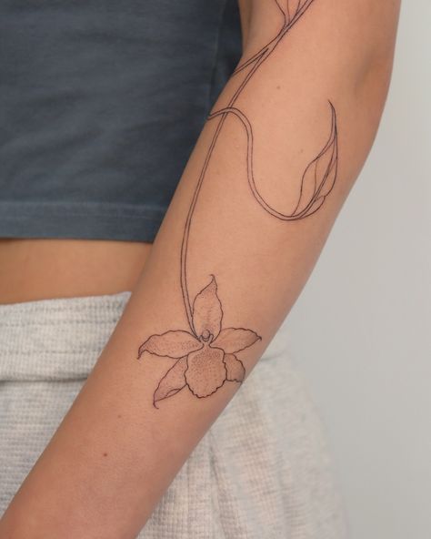 Flowy organic vine 🌿 We added orchid flowers that I shaded with dotwork to keep the delicate soft feel ���🤍 I would looove to do more of these! Orchid Wrap Around Tattoo, Symmetrical Vine Tattoo, Botanical Flow Tattoo, Flowy Botanical Tattoo, Fine Line Floral Vine Tattoo, Orchid Flowers, Orchid Flower, Do More, Vines