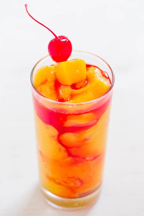 Kiss On The Lips Cocktail - Frozen mango, rum, vodka, peach schnapps, and a KISS of drizzled grenadine!! Fruity, tropical, and they go down way too easily!! Peach Rum, Drink Garnish, Kiss On The Lips, Homemade Baileys, Fruity Alcohol Drinks, Malibu Drinks, Mango Rum, Pineapple Vodka, Day Cocktails