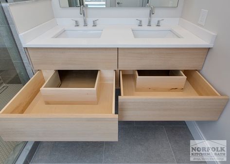 The bathroom in this modern Boston condo was designed by David from our Braintree showroom, in collaboration with the project’s developer: HRV Homes. The design features flat-panel cabinetry from our full-access line: ShowplaceEVO, and a stunning glass shower. The floating vanity features deep double drawers with cut-outs for the dual sink plumbing. Cabinets: ShowplaceEVO Finish: Natural Vanity tops: Unknown David also designed the kitchen in this home. [...] Floating Vanity With Drawers And Shelf, Built In Sink Vanity, Floating Bathroom Vanity With Drawers, Bathroom Drawers Cabinet, Vanity With Drawers Bathroom, Double Vanity With Drawers, Floating Bathroom Vanity Double Sink, Floating Double Vanity Bathroom, Dual Sink Bathroom Vanity