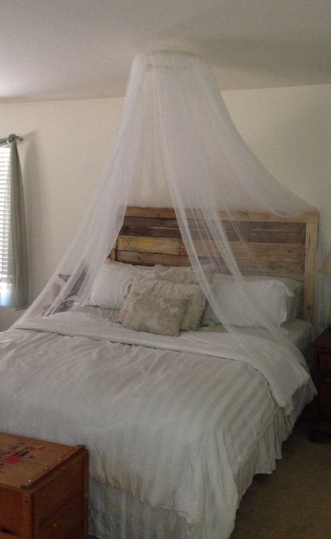 DIY mosquito net canopy.  18" embroidery hoop and 4 110"x 98" Lill sheers from IKEA ($5.00 for a pair).  Tie a ribbon, or string, across from one side to the other then hang from ceiling with a self screwing hook.  Cheap and easy romance!