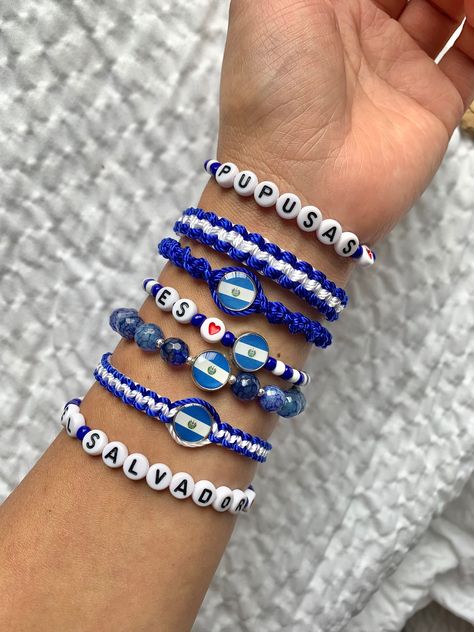 Demuestra tu amor y orgullo por El Salvador 🇸🇻 con estas súper pulseras hechas a mano con muchisimo amor 🥰  Disponibles en azul, blanco y negro . Si deseas un color diferente mandame un mensaje y con gusto te la hago.  #salvypride Please message me with any questions prior to purchase.  Remember that handmade pieces are always unique and they never look exactly the same 🤩 that's why they are so special 😍😉. ️🎁 Follow  me on Instagram  and Facebook for giveaways, special offers and discount Spanish Bracelet, Argentina Bracelet, El Salvador Bracelets, Puerto Rico Bracelet, Country Flag Bracelet, Colombia Bracelet, El Salvador Flag, Pride Bracelet, Clean Cotton